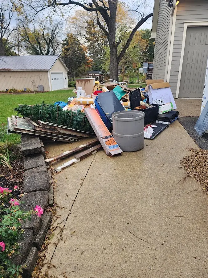 Dumpster being loaded with debris for 12 Yard Dumpster Rental in Black Mountain
